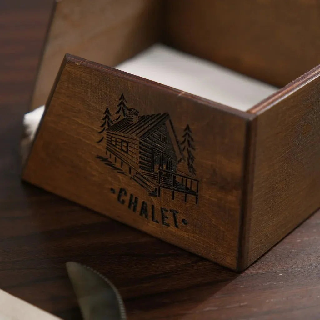 Rustic wood napkin stand for a cozy dining setup.