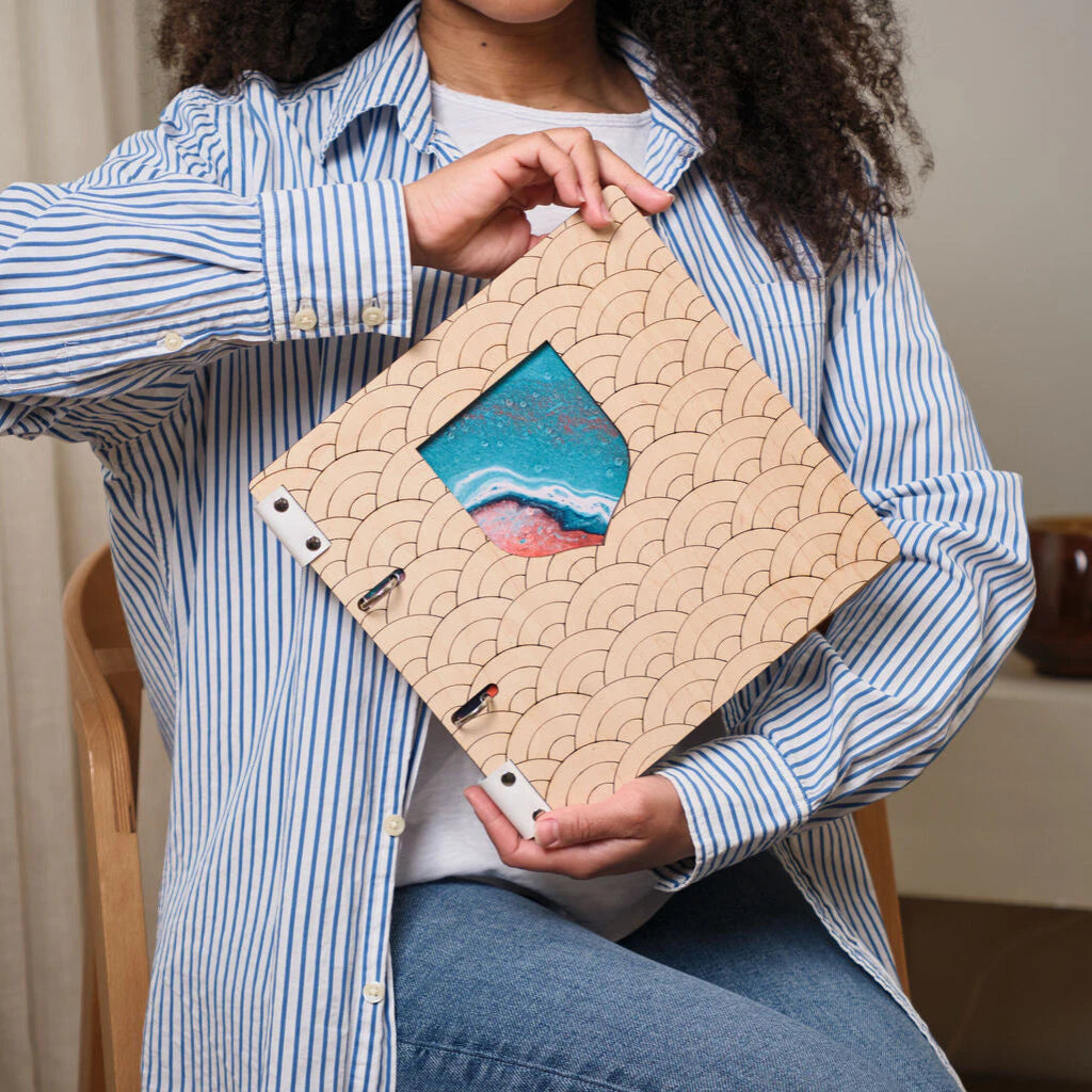 A high-detail interior view of a premium restaurant menu folder made from textured blue wood. The image highlights the professional binding mechanism, featuring two thick black genuine leather straps secured with industrial-style brass screw-post fasteners. The distressed blue wood grain provides a vintage yet modern aesthetic, while the exposed metal hardware ensures durability and allows for easy menu page replacement. This close-up showcases the handcrafted quality and sturdy construction required for hi