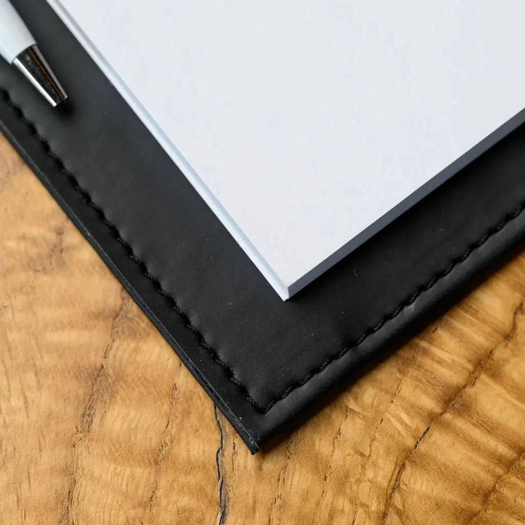 A restaurant order notebook featuring a textured fabric cover and a strong hardcover. The combination of these materials ensures the notebook can withstand frequent use, making it an ideal tool for waiters to manage orders effectively.