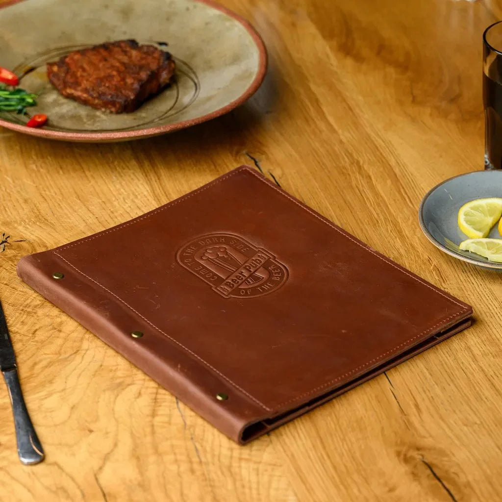 Chic book menu with leather and metal accents.