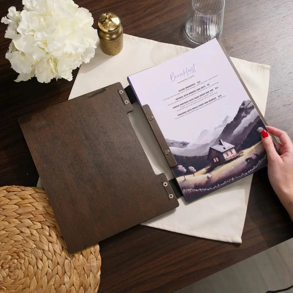 Custom engraved wooden menu cover with restaurant logo.