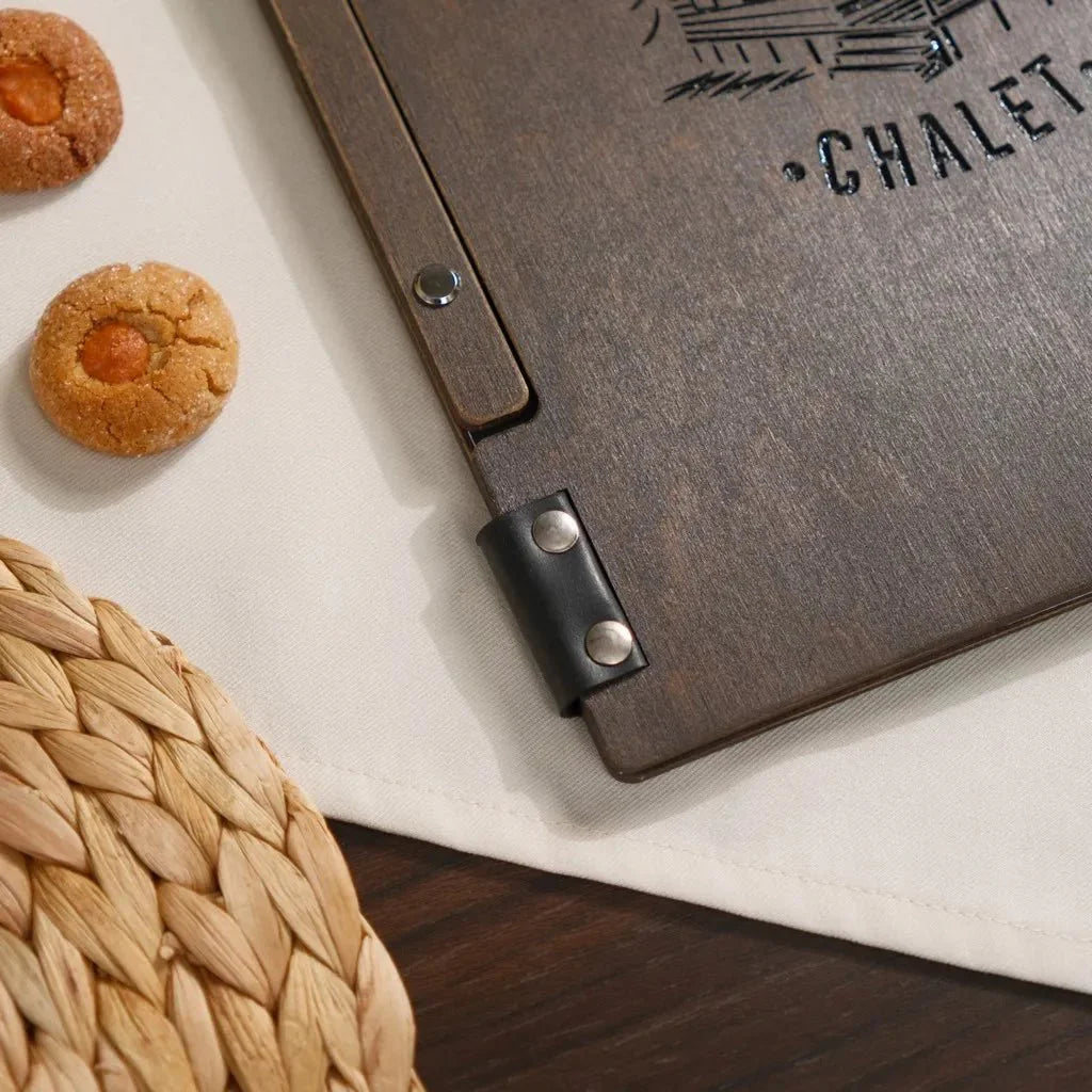 Modern engraved wood menu sleeve for stylish presentation.