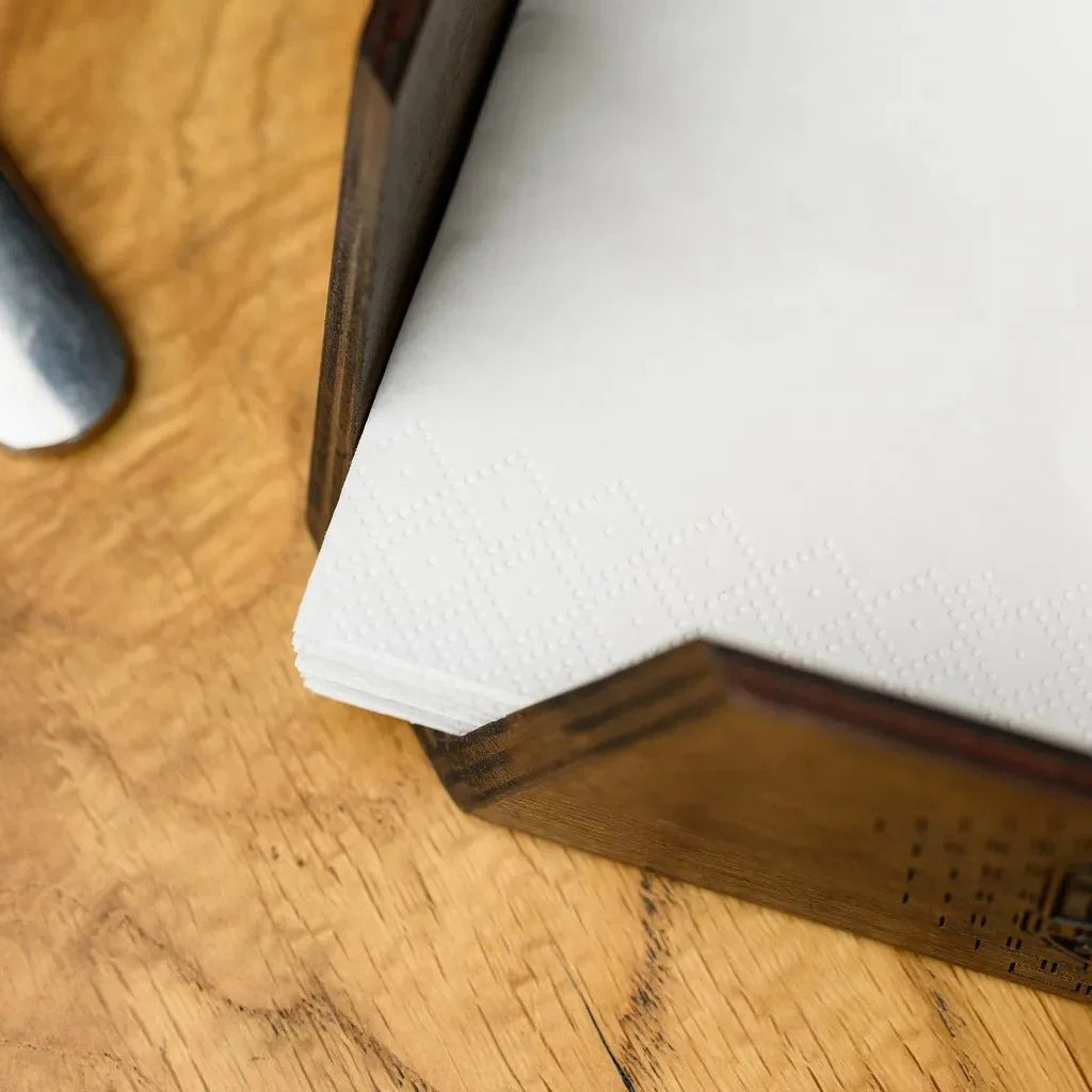 Classic wooden napkin holder with detailed engraving.
