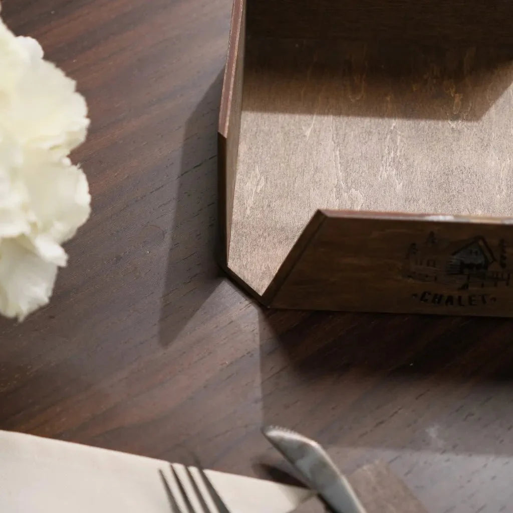 Chic wood napkin basket for a refined table setting.