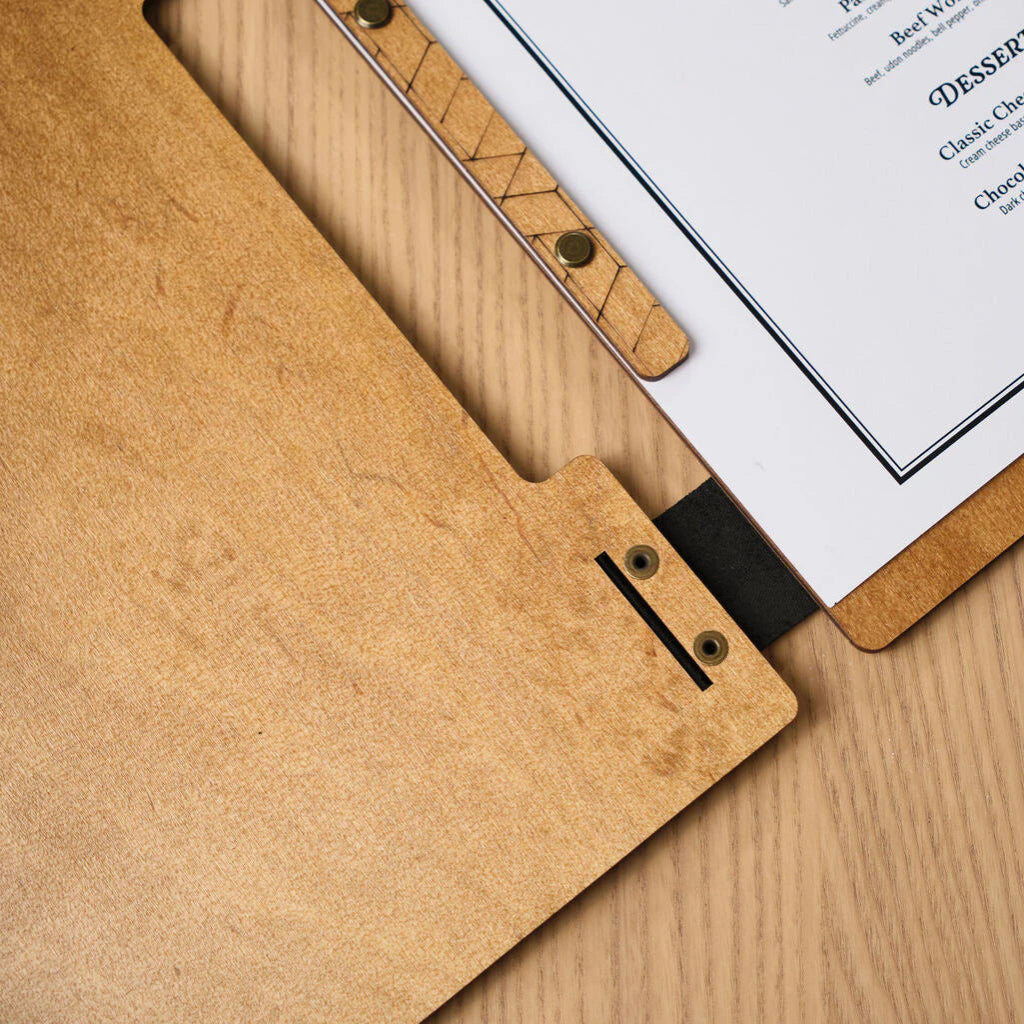 Detailed photo of the bottom corner of the board, showing clean laser-cut slots in the wood and metal eyelets for secure assembly