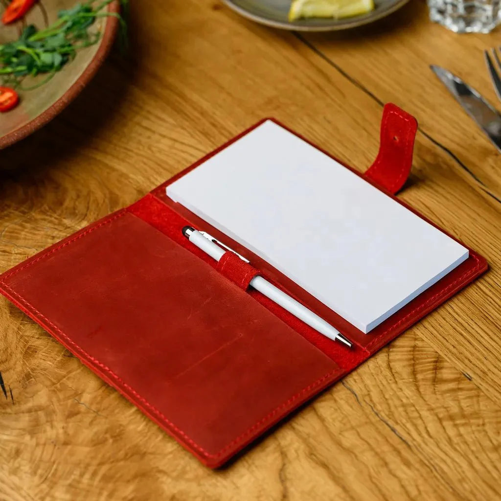 Professional waiter’s notebook crafted from full-grain Crazy Horse leather, featuring a sturdy closure for secure storage of important notes and receipts.
