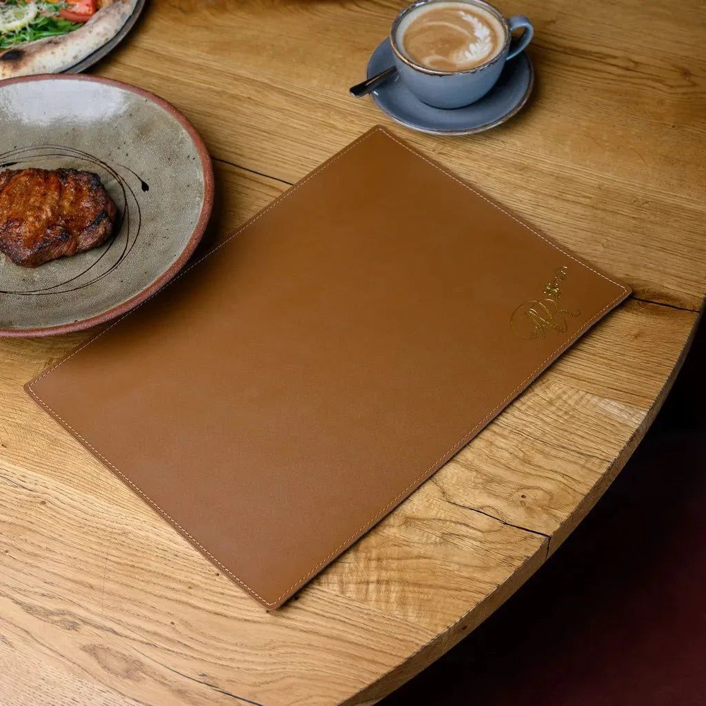 Modern rectangular leather placemat protecting table surface from scratches.