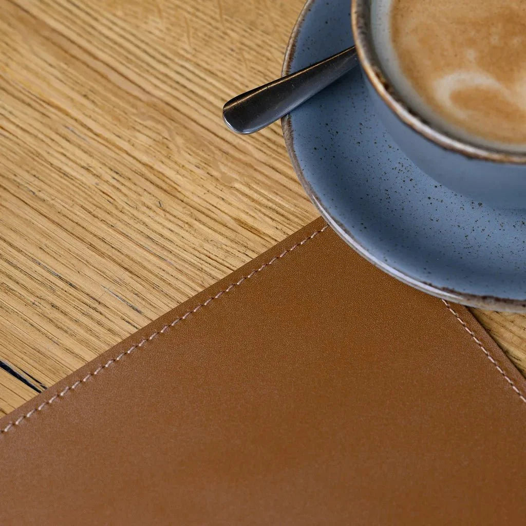 Protective leather placemat for modern dining table settings.