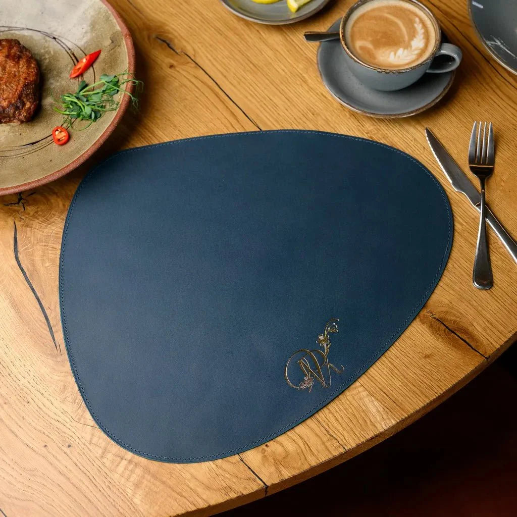 Teardrop-Shaped Placemat in Capri leather, designed for elegant dining. Durable, stylish, and easy to clean, perfect for enhancing any table setting with sophistication.