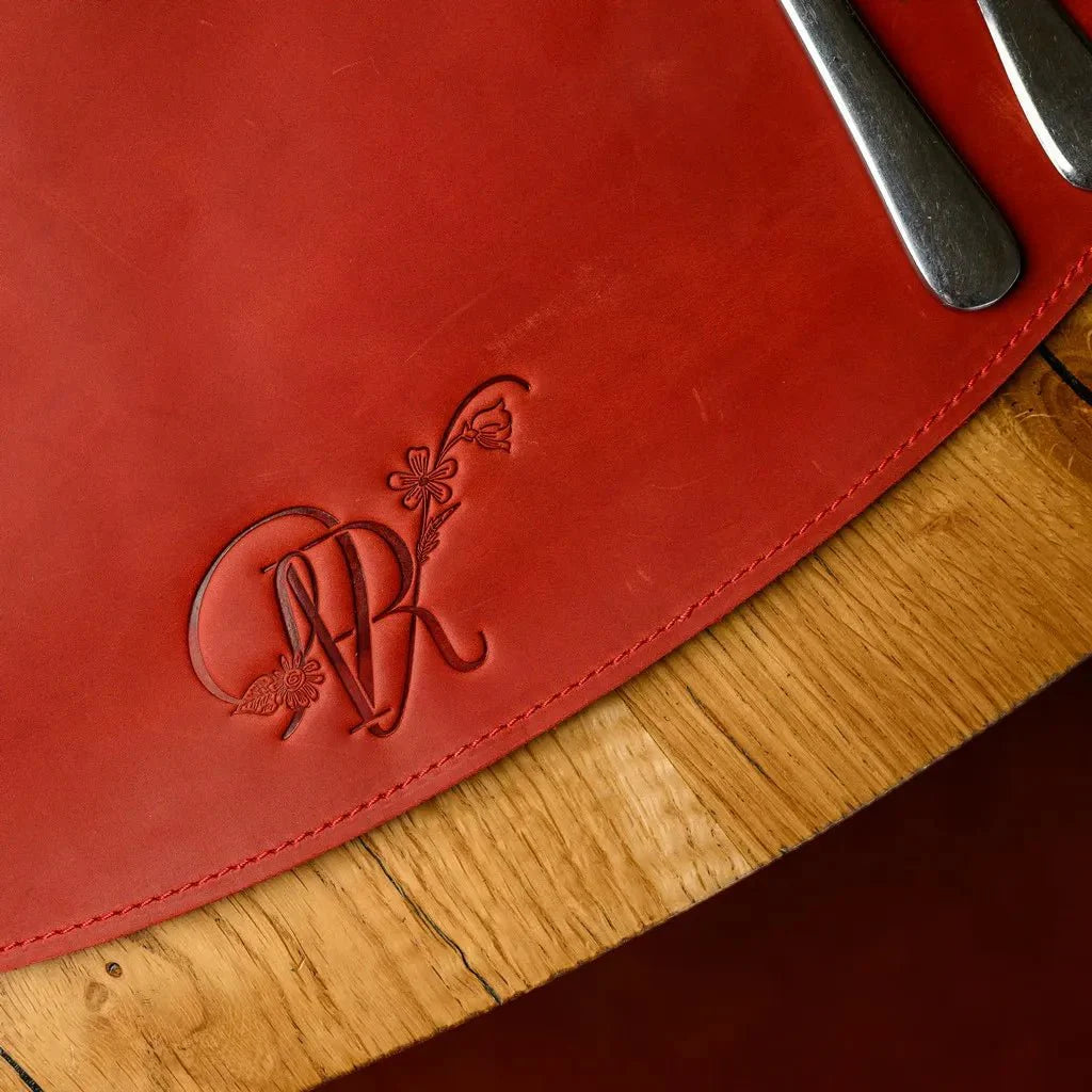Rustic brown teardrop-shaped placemat made from high-quality Crazy Horse leather. Adds durability and a unique aged patina to any dining table setup.
