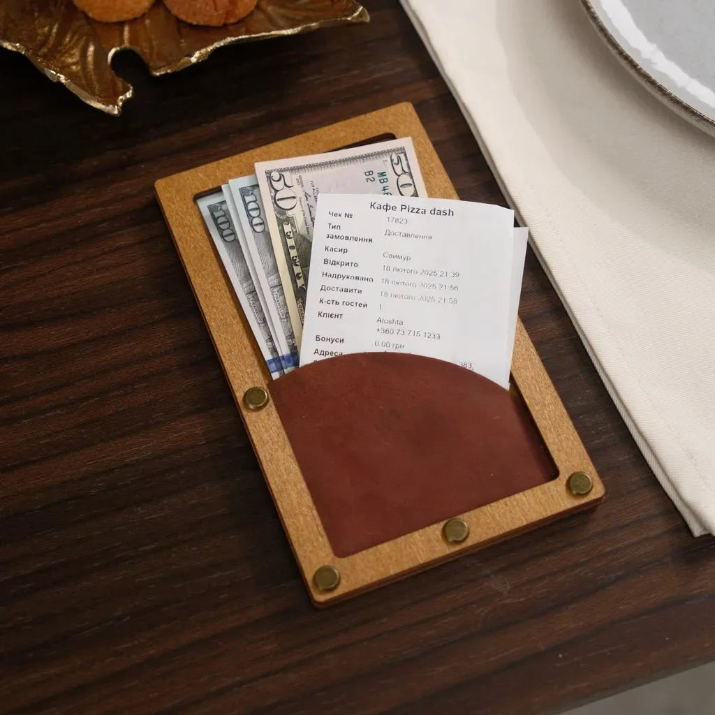 Compact wooden check holder for easy handling.