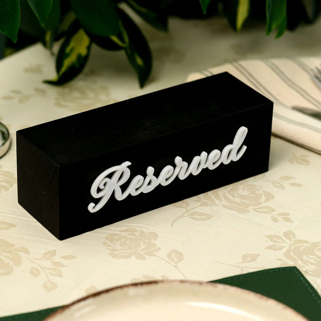 Handcrafted black wooden table marker with "Reserved" 3D white acrylic lettering. Horizontal design, textured finish, ideal for luxury restaurant branding and table management