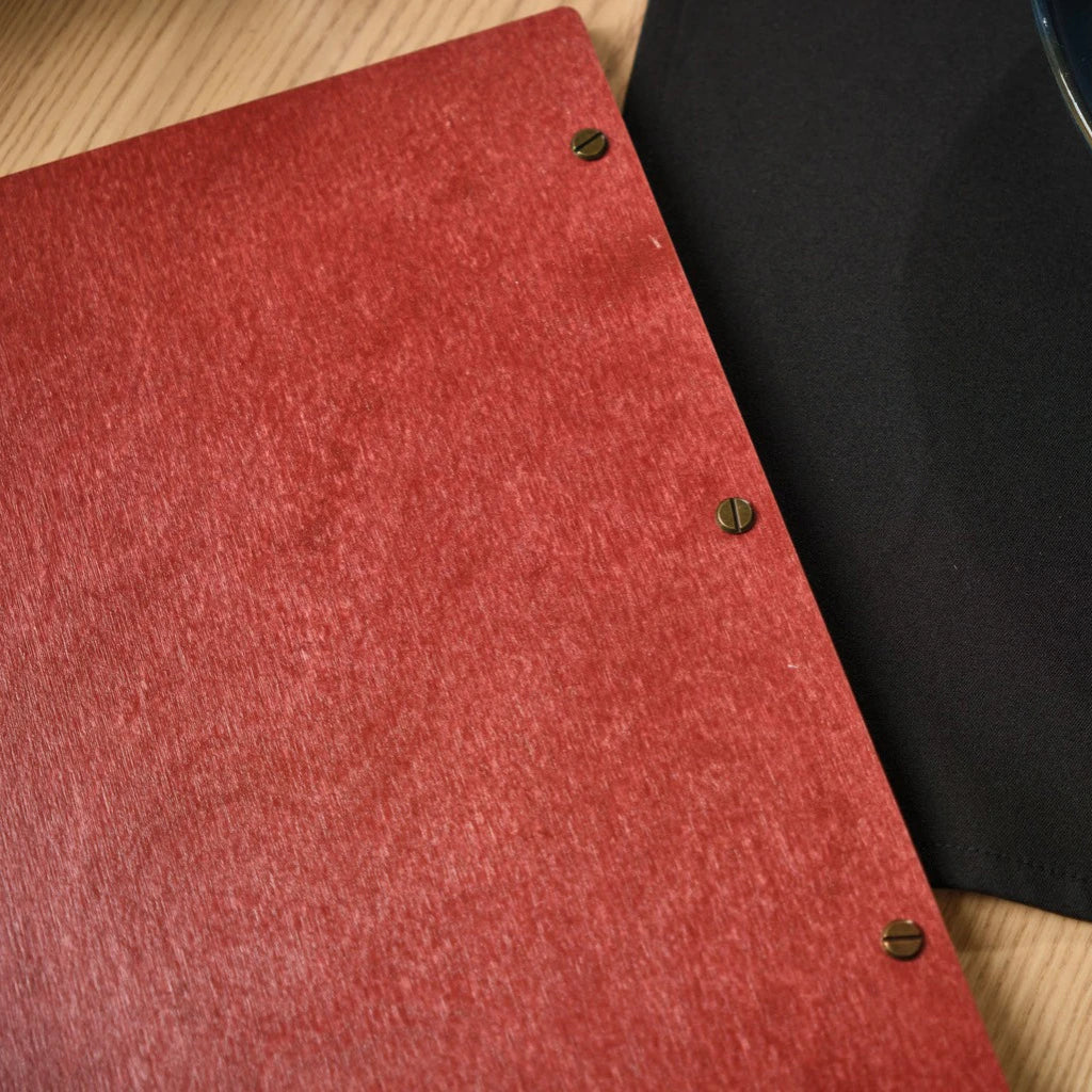 Rear view of a red wooden menu folder showing the secure bronze screw-post binding. This handcrafted wood menu cover features a durable textured finish and professional metal hardware for heavy-duty restaurant use