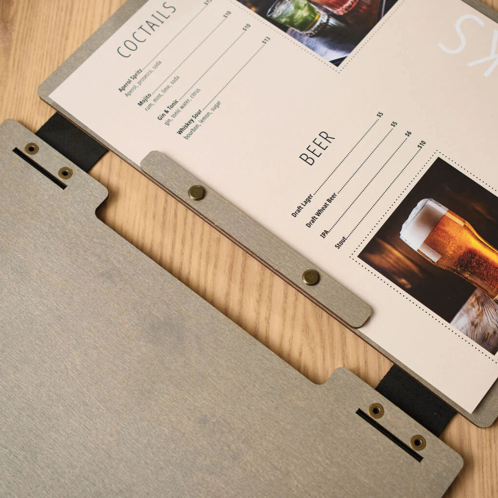 An open grey wooden menu folder displaying a professional drinks list for cocktails and beer, complete with high-quality food photography and clear typography.