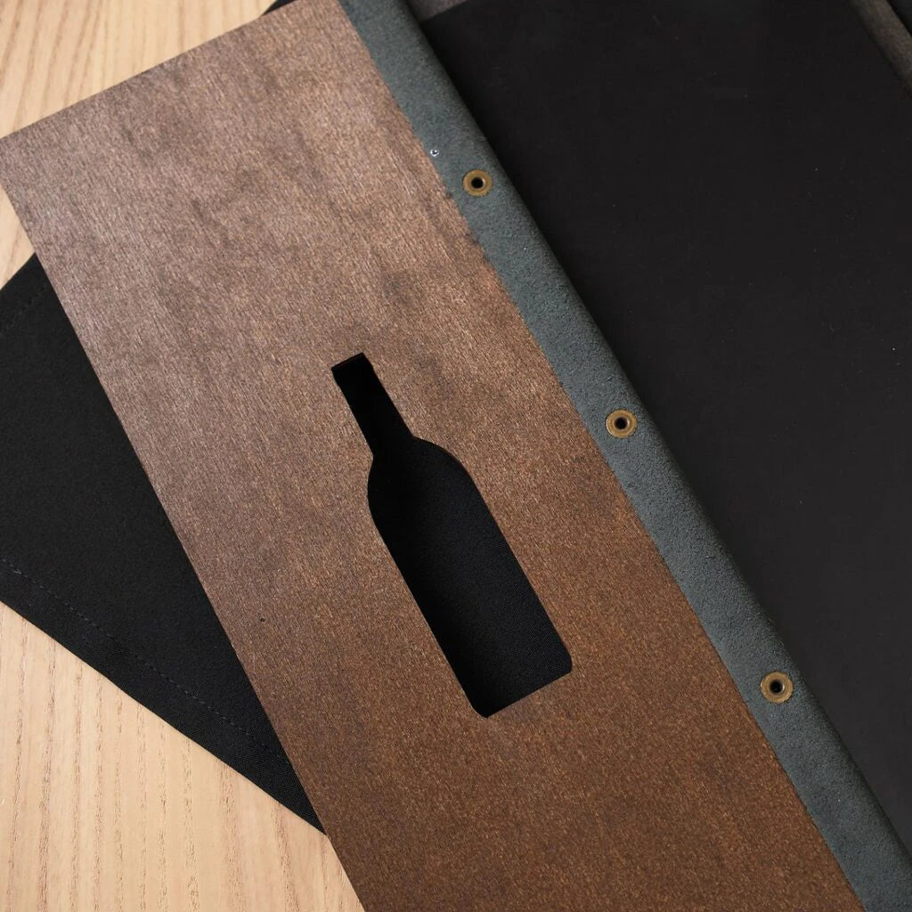 A close-up view of the opened walnut folder, showing the internal black leather-style spine strip with three brass-colored metal eyelets.