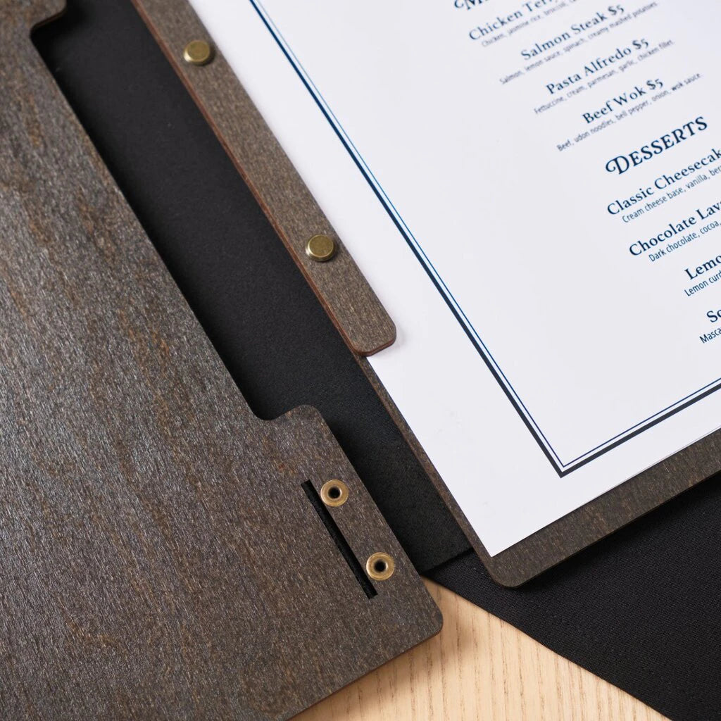 A matching wooden strip with brass screws securely clamps the printed menu pages in place