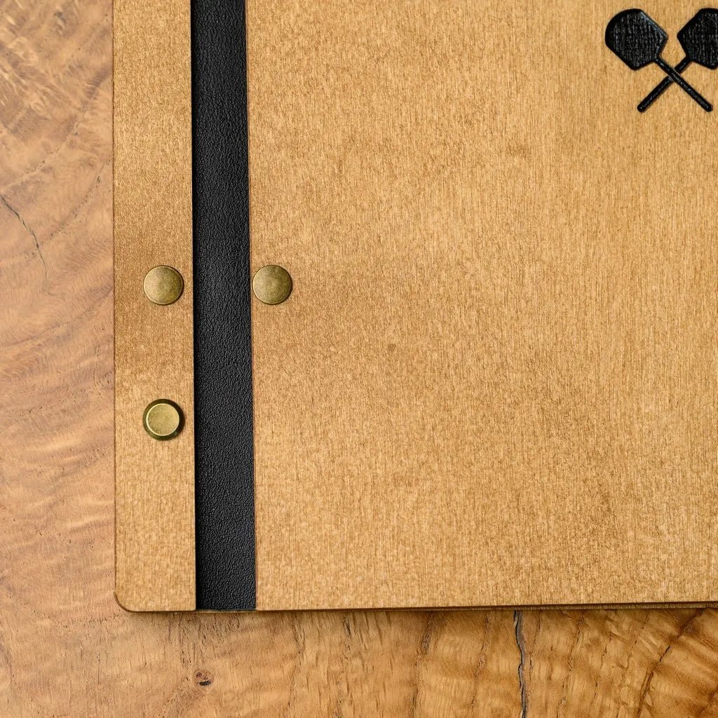 Custom restaurant wooden menu cover with engraved branding.
