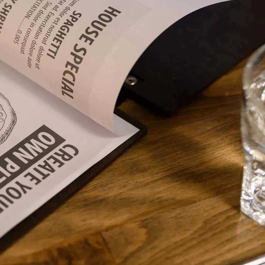 Personalized restaurant menu book with engraved details.