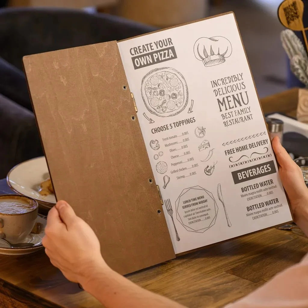 Artistic menu book featuring carved wooden details.