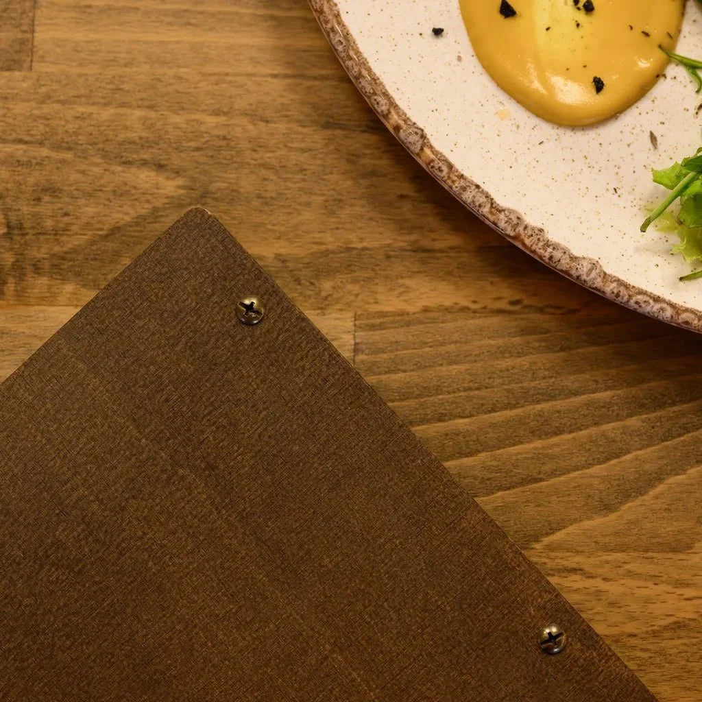 Wooden menu folder with a classic engraved logo.