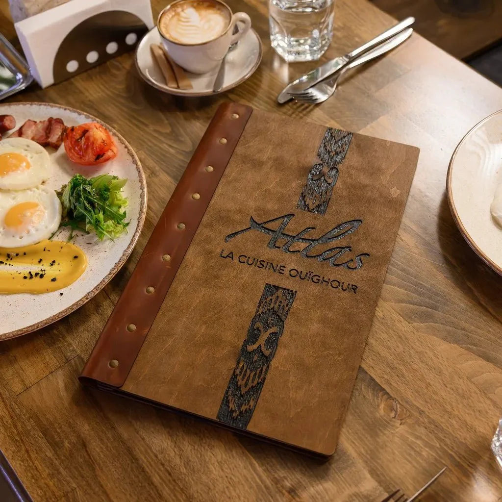 Custom restaurant menu cover with engraved branding.