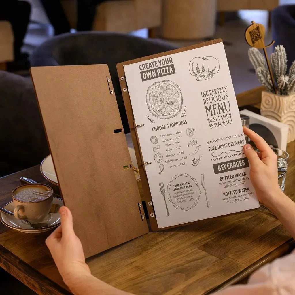 Premium menu covers restaurant with embossed branding.