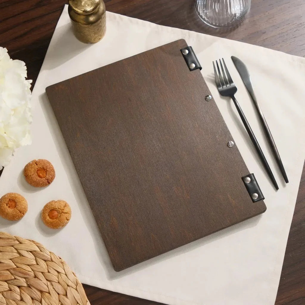 Stylish wooden menu folder with engraved logo design.