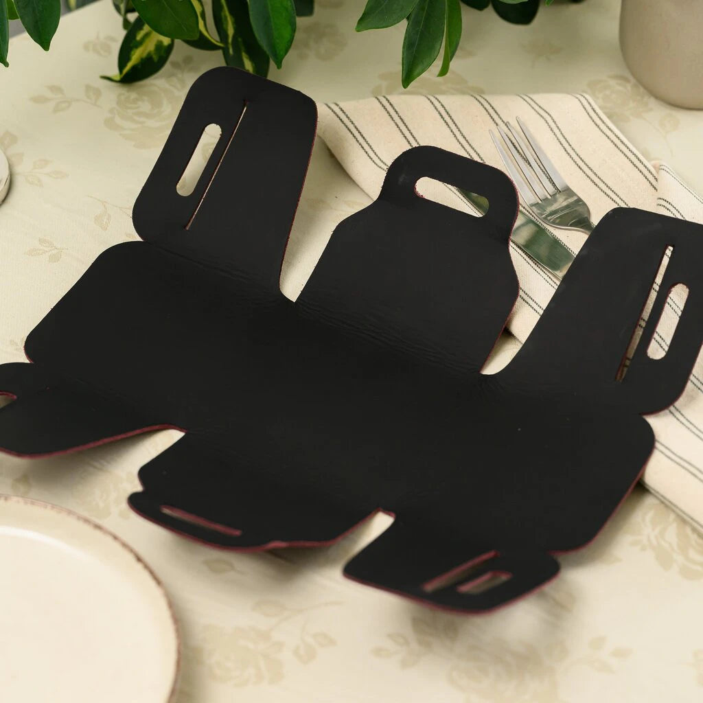 Flat lay view of a disassembled burgundy leather bread basket showing its one-piece pattern design.