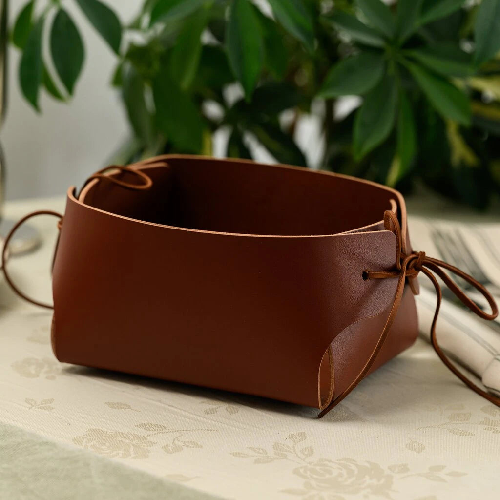 Stylish leather tabletop organizer or bread bin in a warm cognac color, featuring a rustic lace-up design