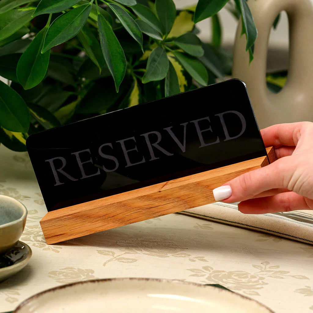Minimalist black and oak wood reservation sign for wedding receptions or cafes, featuring a clean matte finish and laser-etched text