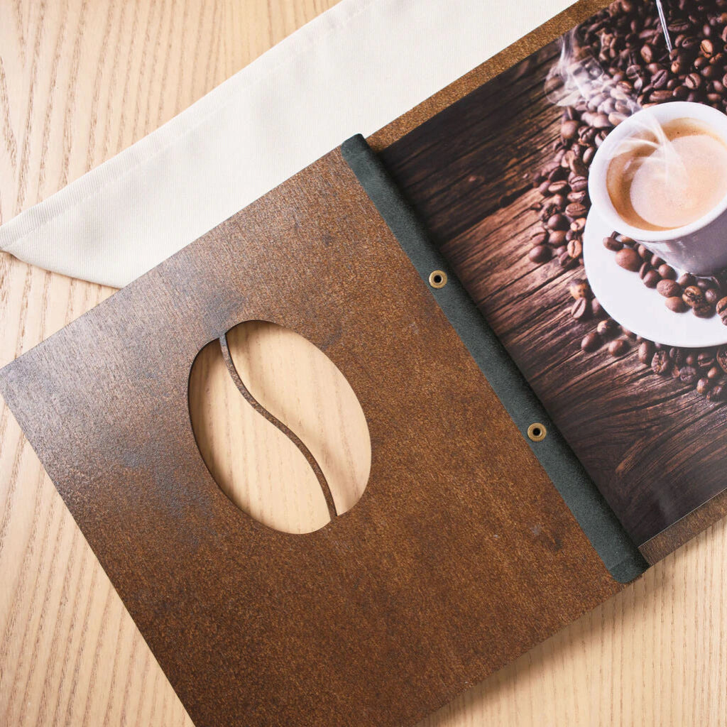 Walnut wood menu cover featuring an engraved pattern of horizontal parallel lines and a coffee bean shaped cutout.