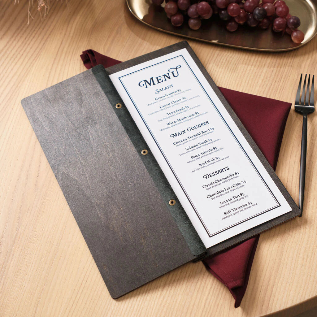 The menu folder opened flat on a table, revealing a white printed menu insert with blue accents listing salads, main courses, and desserts.