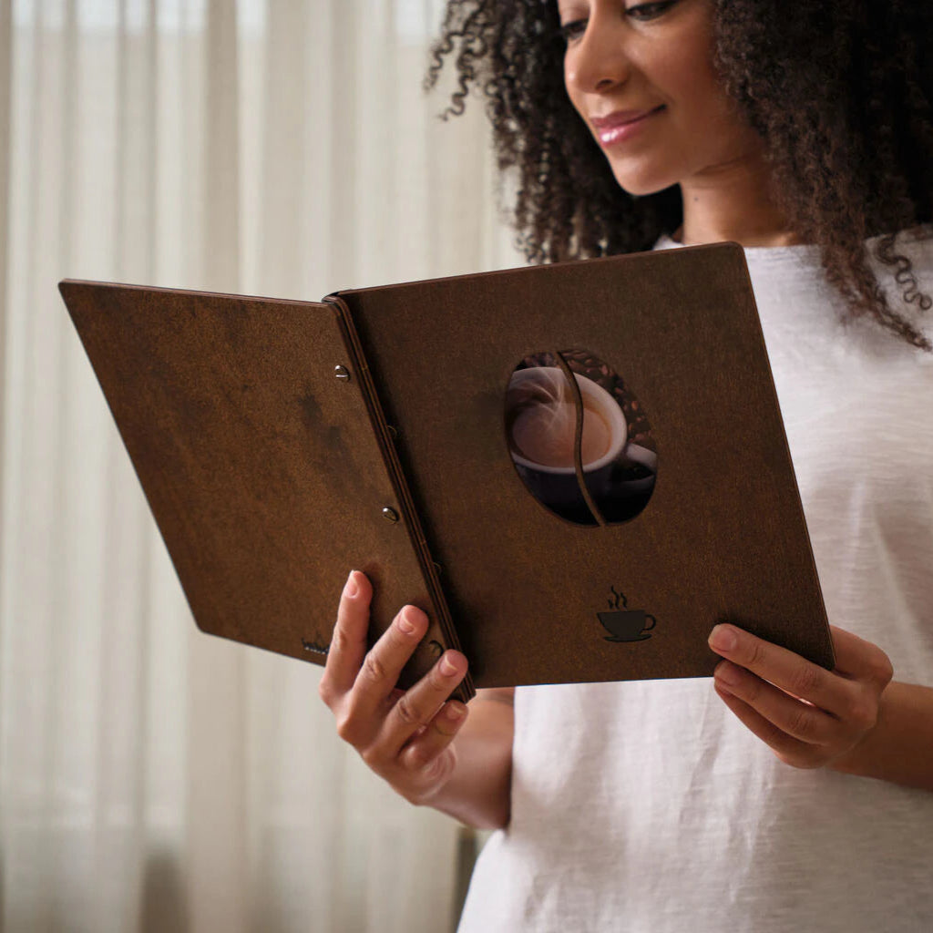 Side view of a wood menu folder highlighting the durable leather binding and brass hardware.