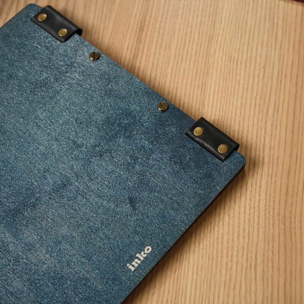 Interior view of a blue wooden menu folder showcasing the secure metal screw-post binding and black leather hinge system.