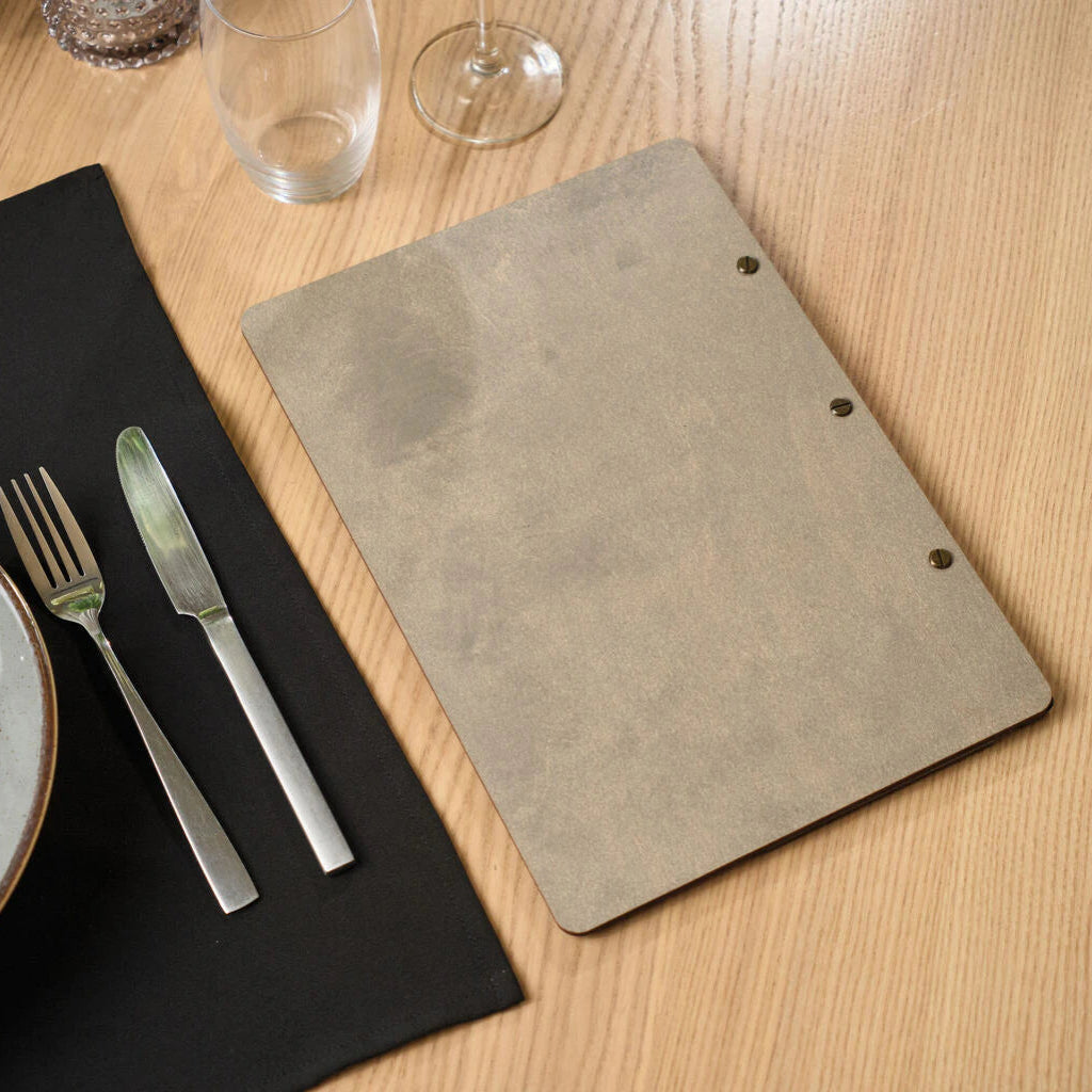 Back view of a premium gray wooden menu board with three visible antique brass screw fasteners on a light wooden tabletop