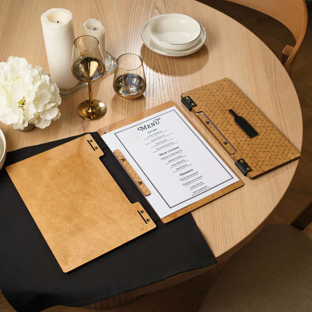 A wooden menu board next to a wine list featuring geometric engraving and a bottle-shaped decorative element