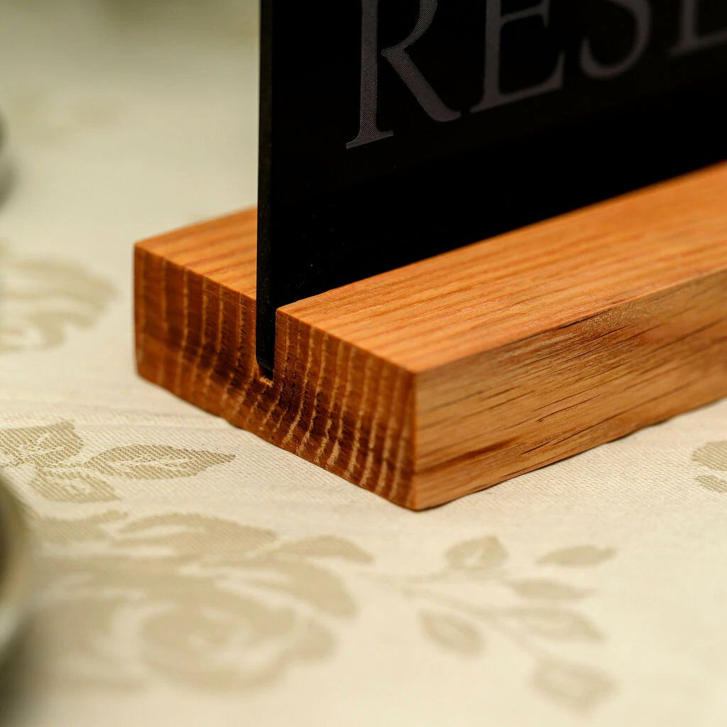 Close-up of the high-quality wood grain texture on a minimalist table sign holder for restaurants and cafes