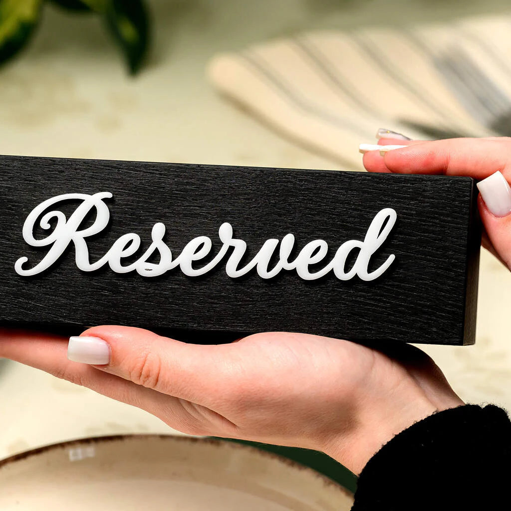 Handcrafted black wooden table marker with "Reserved" 3D white acrylic lettering. Horizontal design, textured finish, ideal for luxury restaurant branding and table management