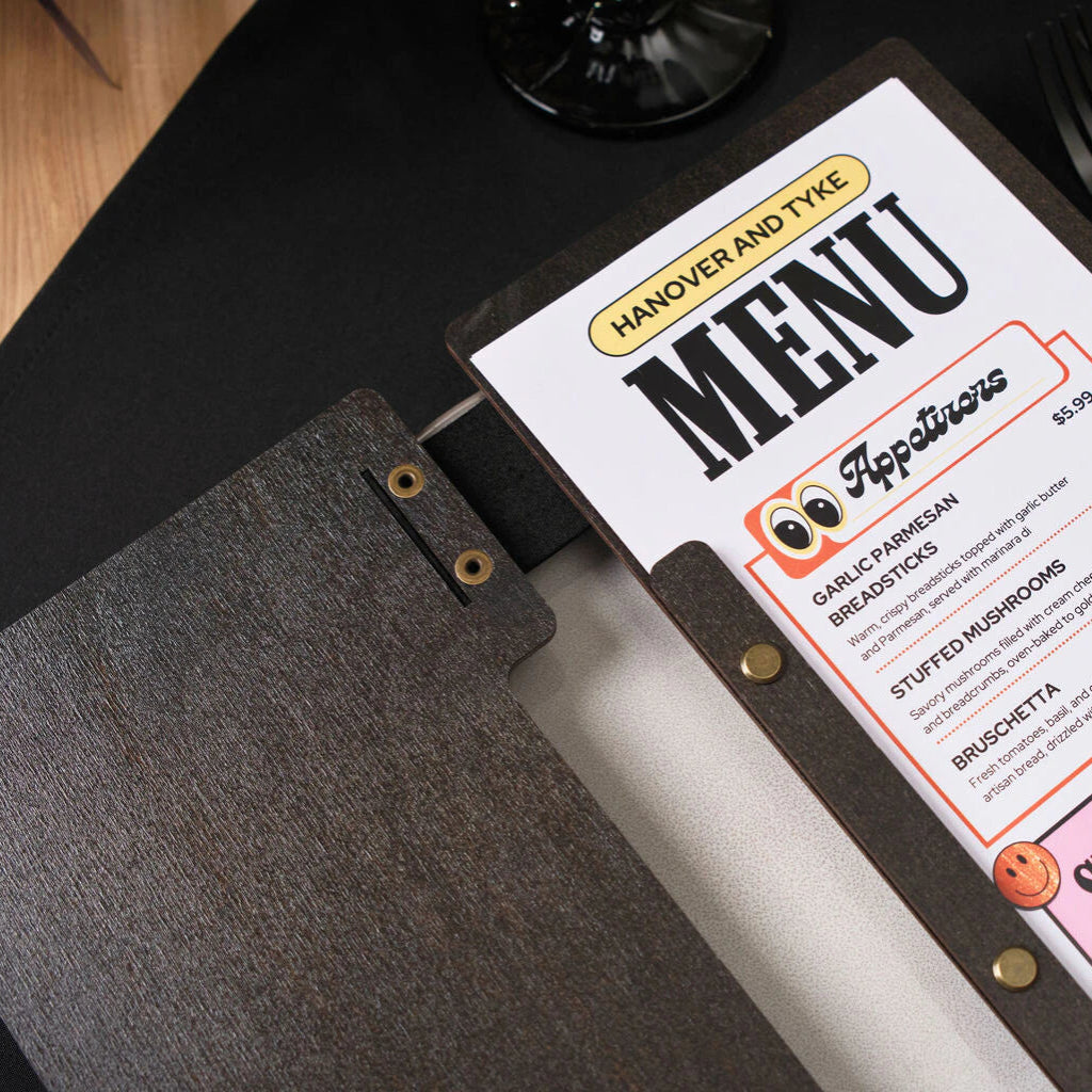 The folder opens to reveal a printed menu insert, held in place by a series of brass-colored screws that allow for multiple pages to be secured.
