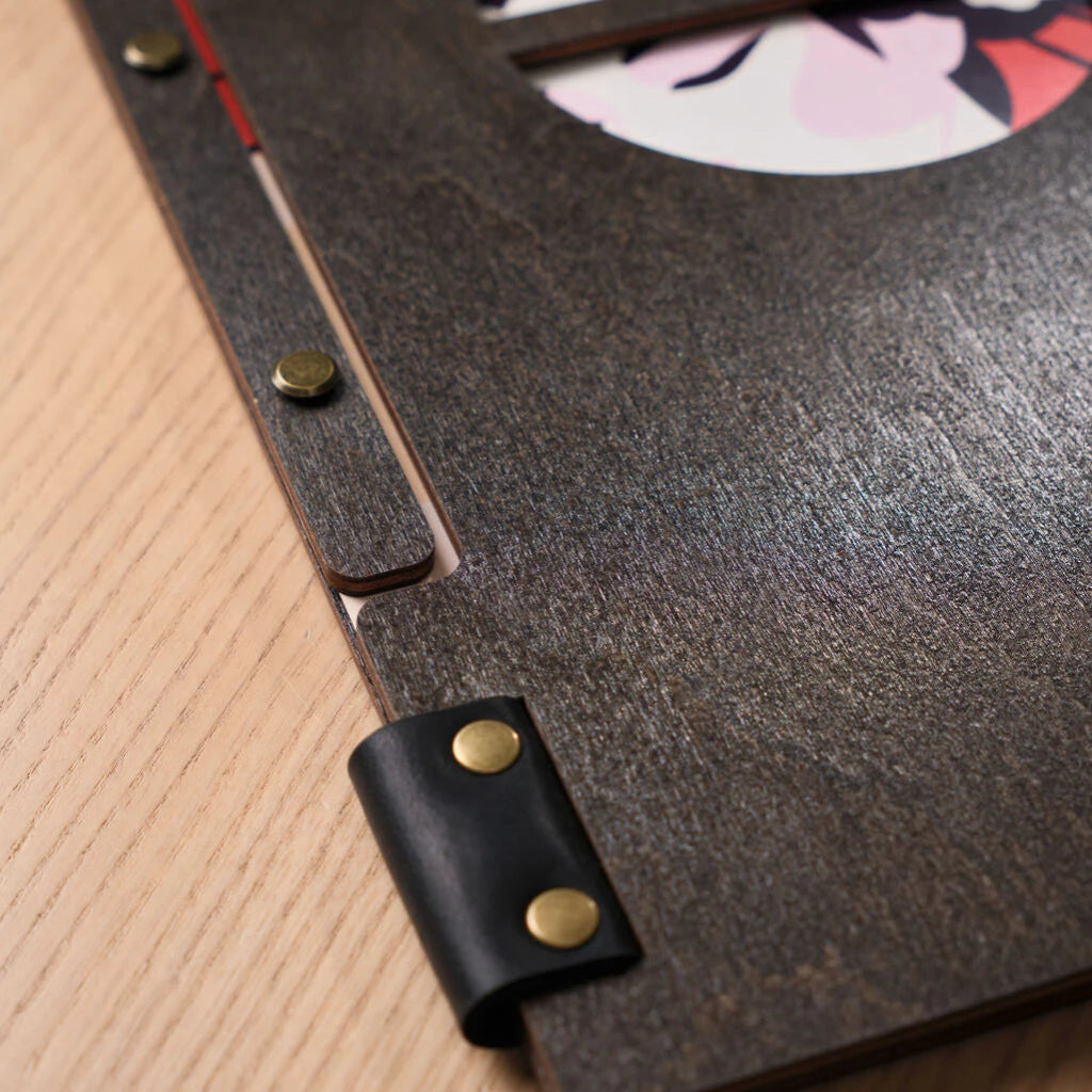 Close-up focus on the brass screws and leather binding.