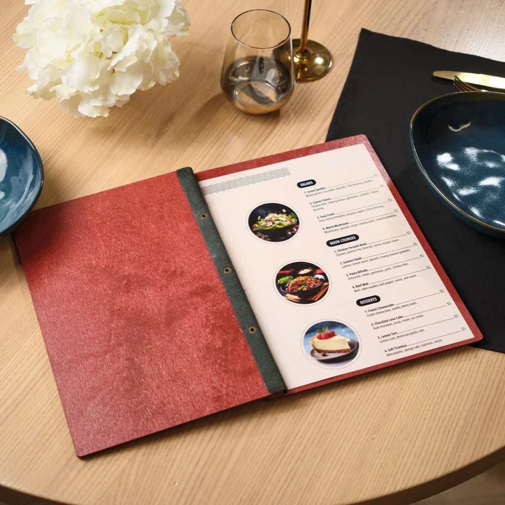 Internal view of an open red wooden menu folder showing professional printed inserts for salads, main courses, and desserts. Features a handcrafted wood cover with a durable black leather hinge and secure bolt binding