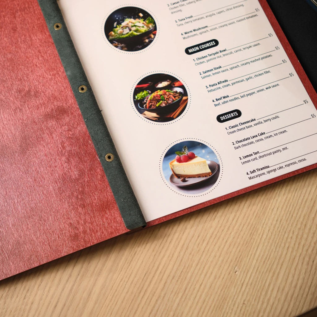 Close-up of an open red wooden menu folder featuring high-quality printed inserts with dish photos and prices. The handcrafted wood menu cover includes a flexible black leather spine and professional bronze screw-post binding