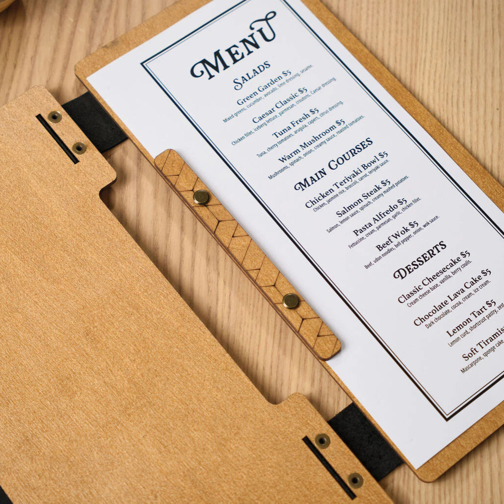 A detailed view of a wooden menu folder's interior, showcasing the contrast between the natural oak wood grain and the black leather binding strap secured with gold-toned rivets.