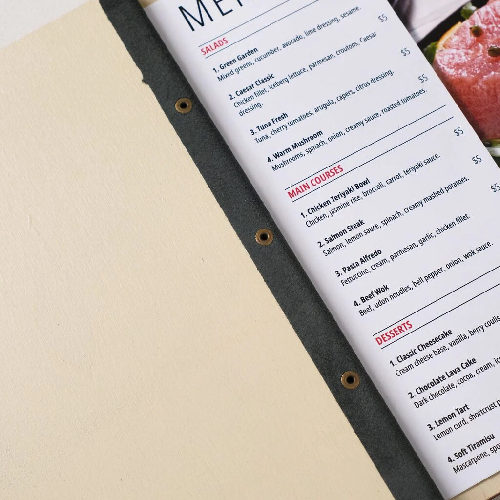 Open wooden menu holder with printed restaurant menu showing salads, main courses and desserts sections