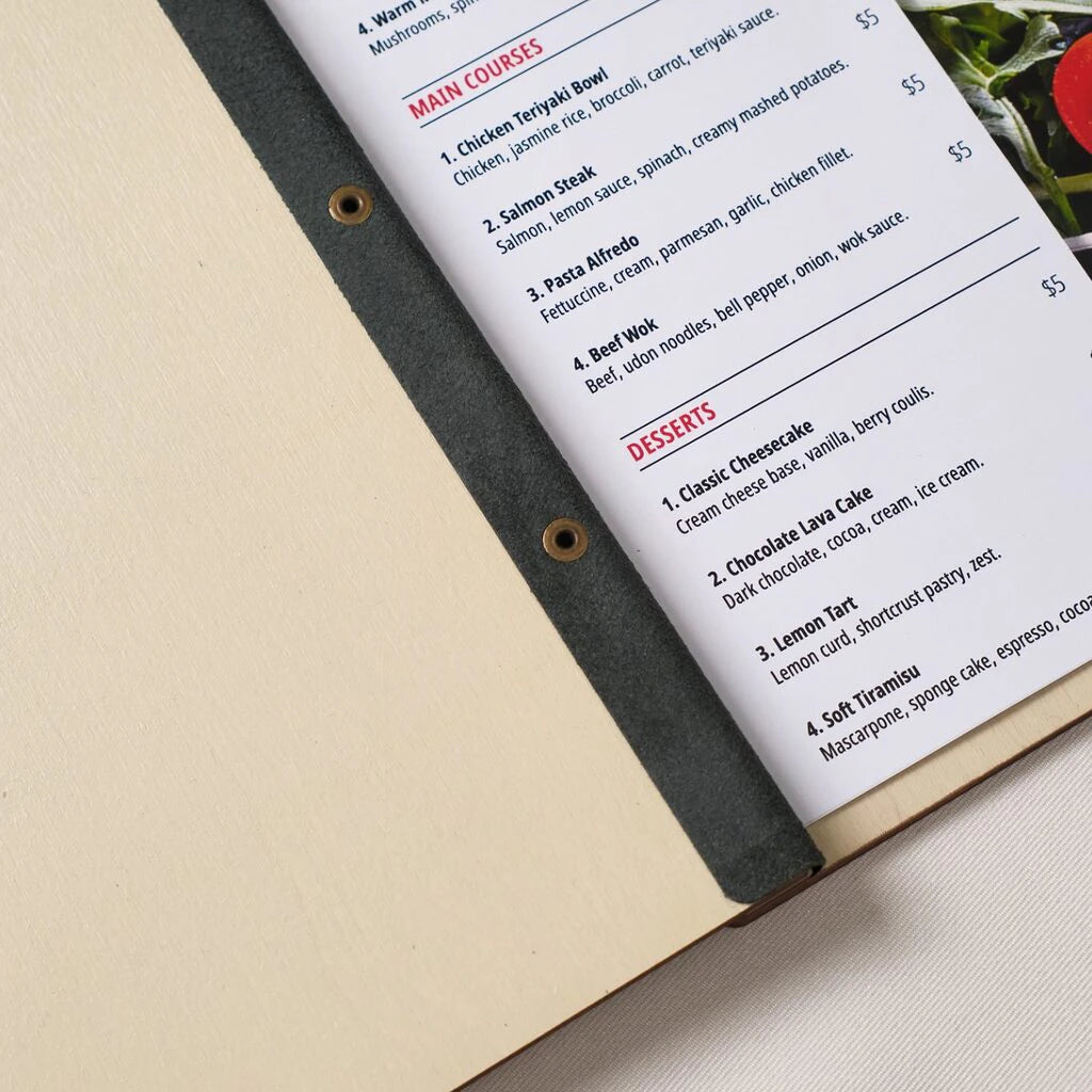 Open wooden menu holder with printed restaurant menu pages showing main courses and desserts