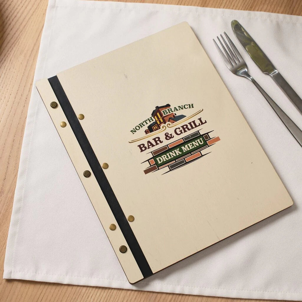 Light birch wood menu holder for "North Branch Bar & Grill" featuring a full-color UV-printed logo. The design includes a black leather spine secured with several brass-tone rivets on both the front and back panels, utilizing a durable screw-post binding system