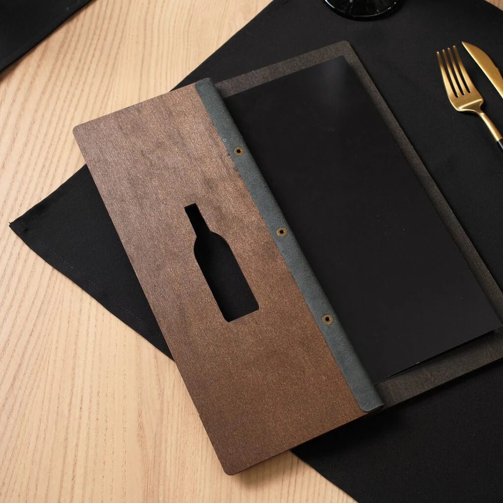 A full-length shot of the opened walnut menu folder, displaying the contrast between the dark wooden exterior and the black internal pages.