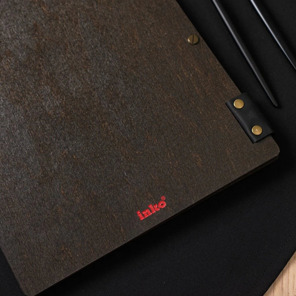 Detail of the lower corner showing the red "inko" logo and black leather binding