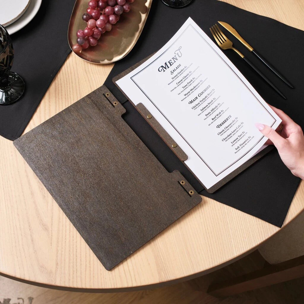 The dark wenge wood is styled to complement sophisticated table settings, including black linens and gold-toned cutlery