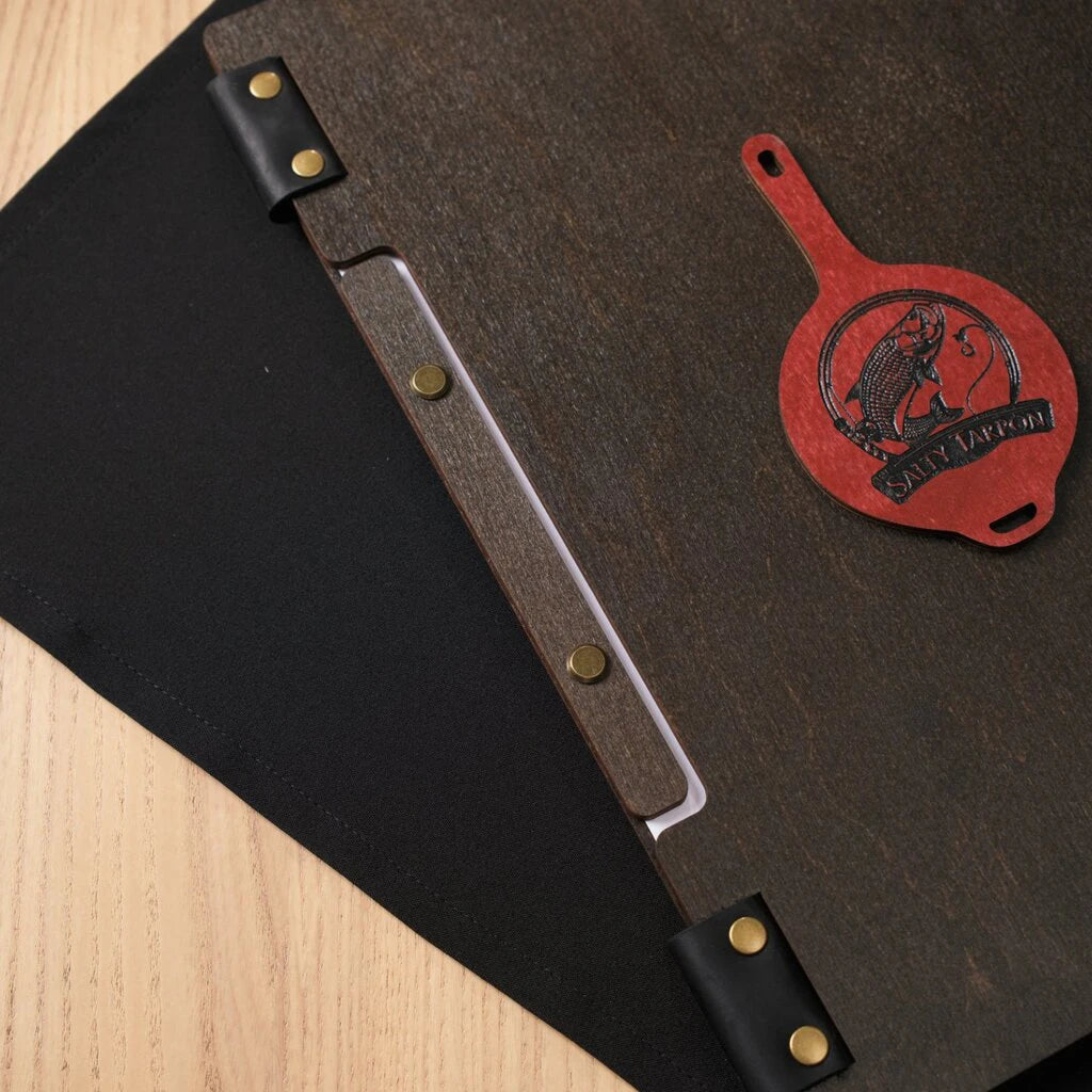 Detail of the black leather hinge and the red "Salty Tarpon" leather logo.